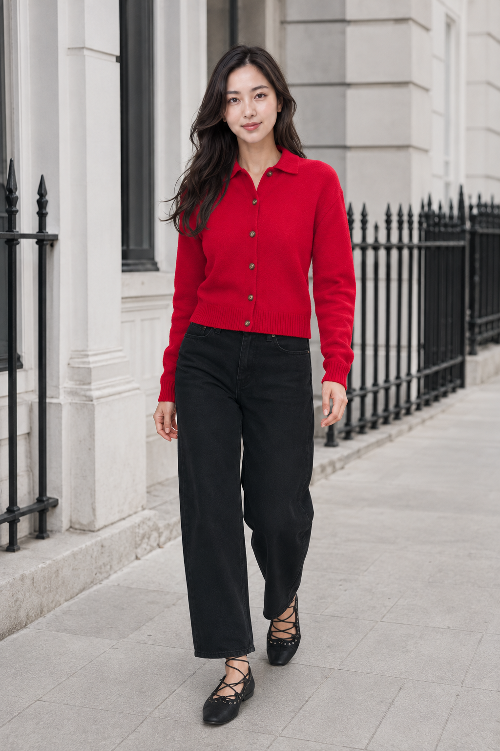 Full-body editorial photograph of Hana in a bright-red Abercrombie collared cardigan with no-fade black relaxed jeans and black Boho lace-up flats